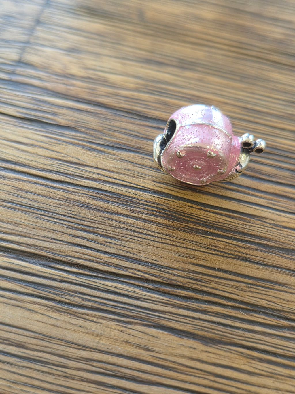 Pink snail charm