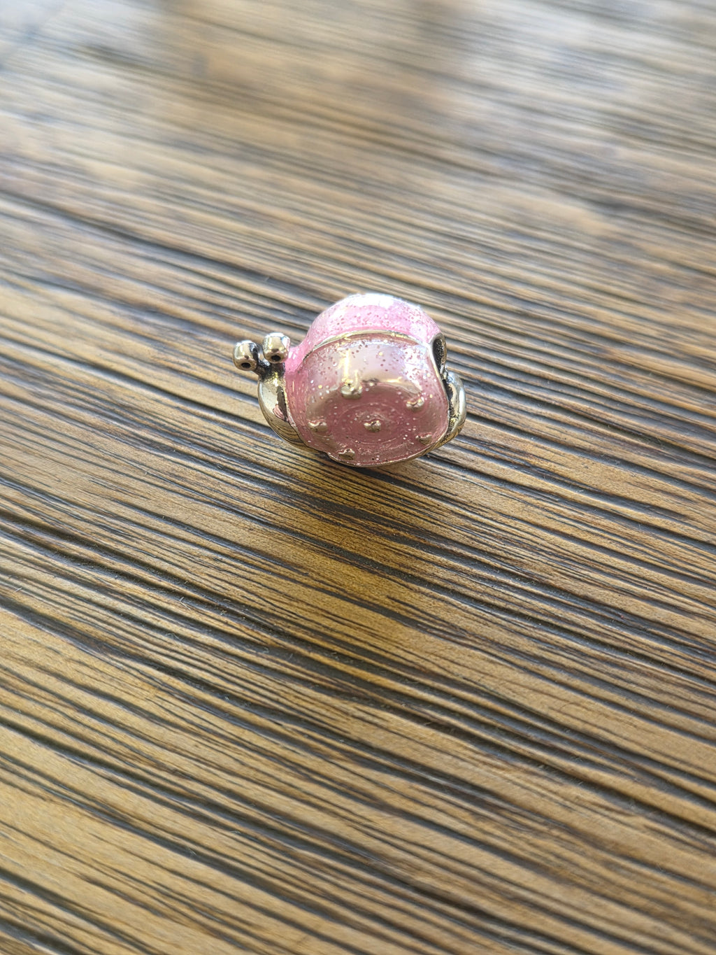 Pink snail charm
