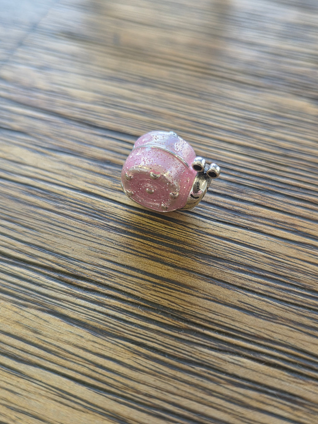 Pink snail charm