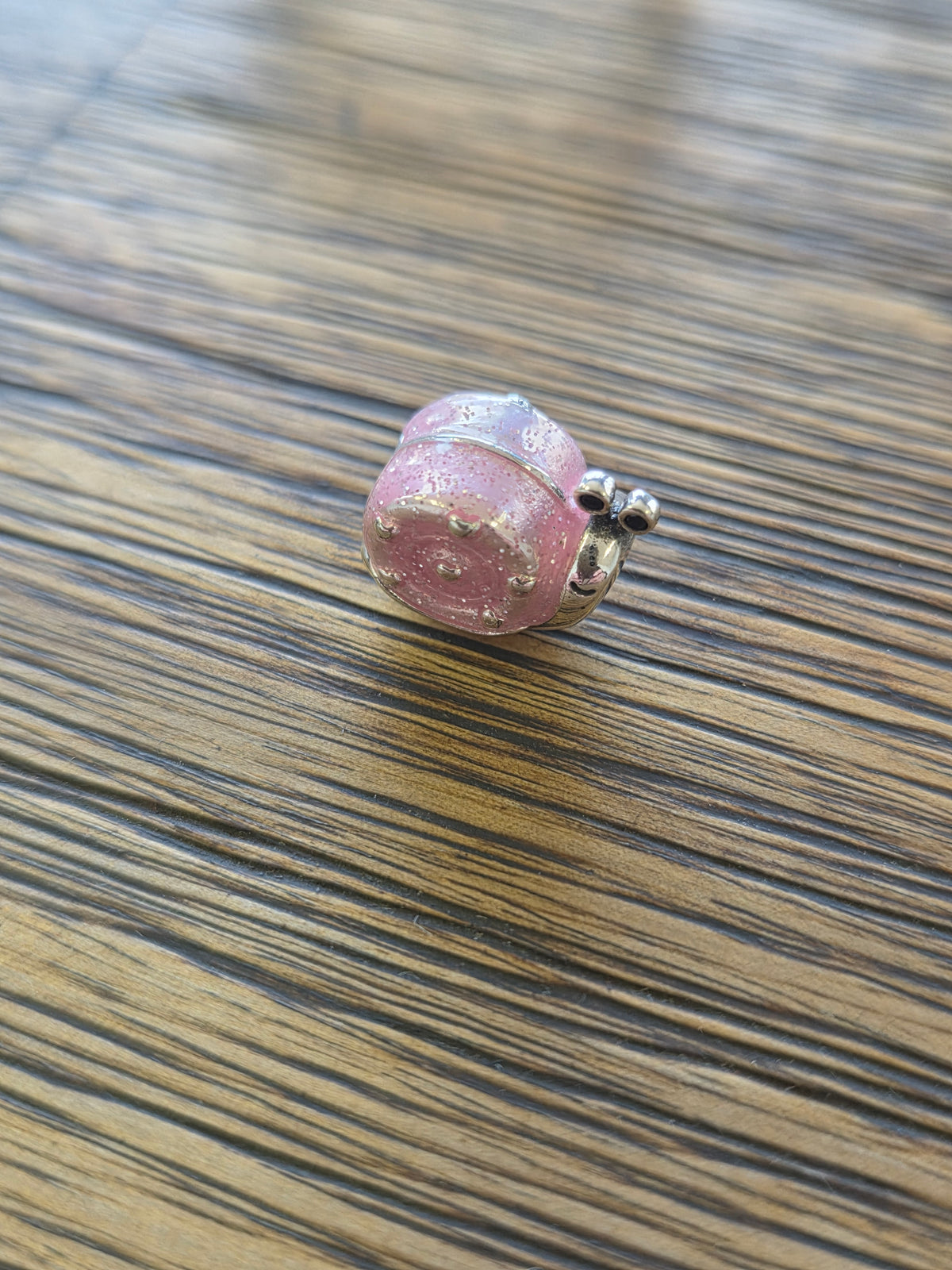 Pink snail charm